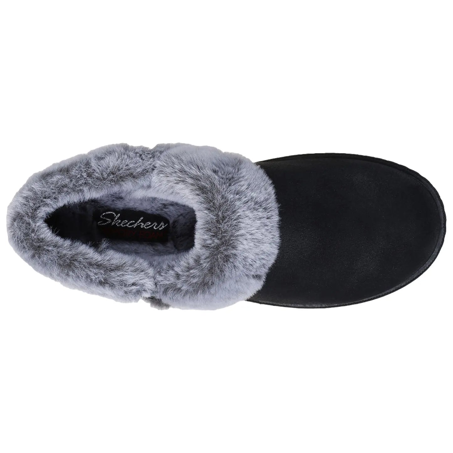 A black slipper with a gray fur lining rests on a flat surface showcasing its cozy design and branding that reads Skechers Memory Foam inside the opening.