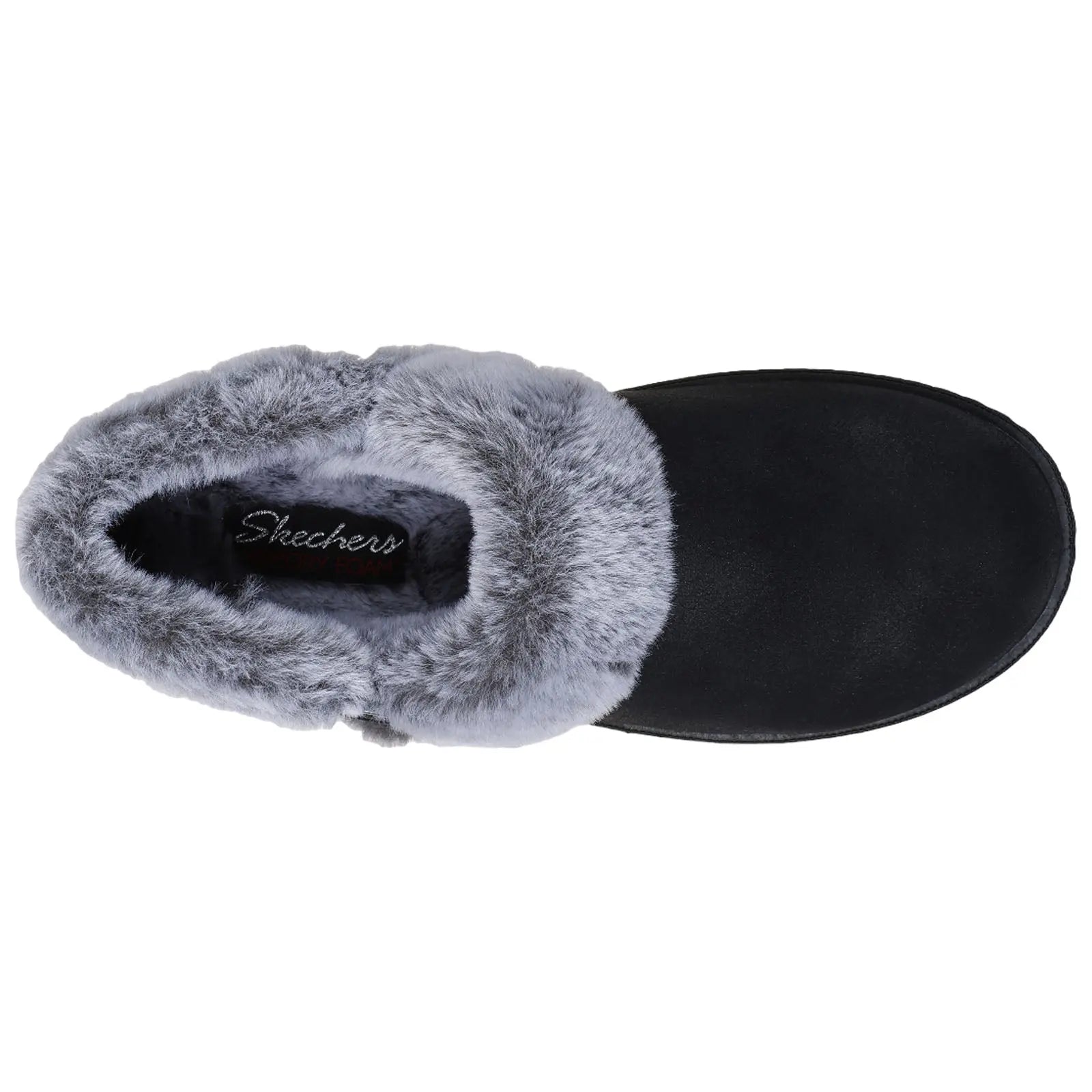 A black slipper with a gray fur lining rests on a flat surface showcasing its cozy design and branding that reads Skechers Memory Foam inside the opening.