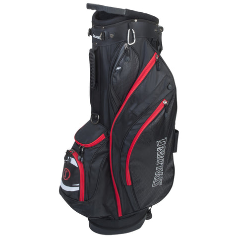 A black golf bag with red accents stands upright featuring multiple zippered pockets for storage and a top section for holding clubs designed for outdoor golfing purposes.