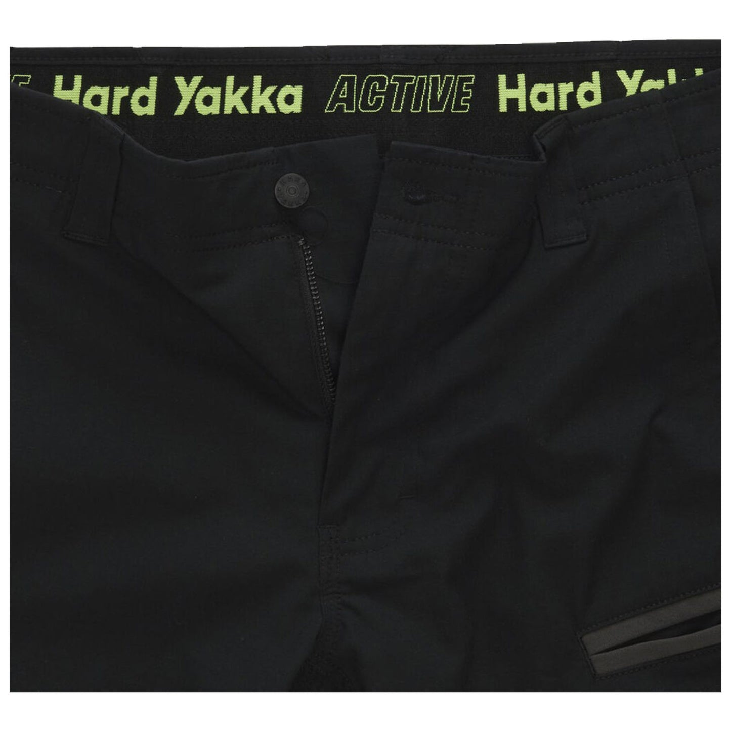 Black pants are displayed with a visible zipper and button closure featuring a waistband that has the text "ACTIVE Hard Yakka" in bright green writing along the top edge.