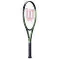 A tennis racket stands upright with a black handle and a green frame The strings form a mesh at the head displaying a red logo on a white background