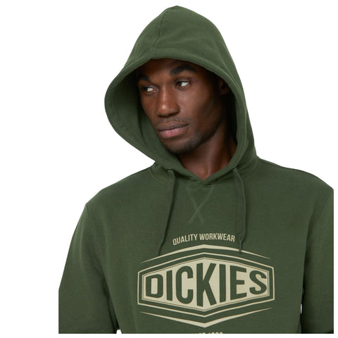 A young man with a serious expression wears a green hoodie featuring the brand name in large letters. He is facing slightly to the side against a plain background.