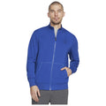 A man wears a bright blue zip-up sweatshirt with two front pockets while standing with one hand in a pocket against a plain white background.