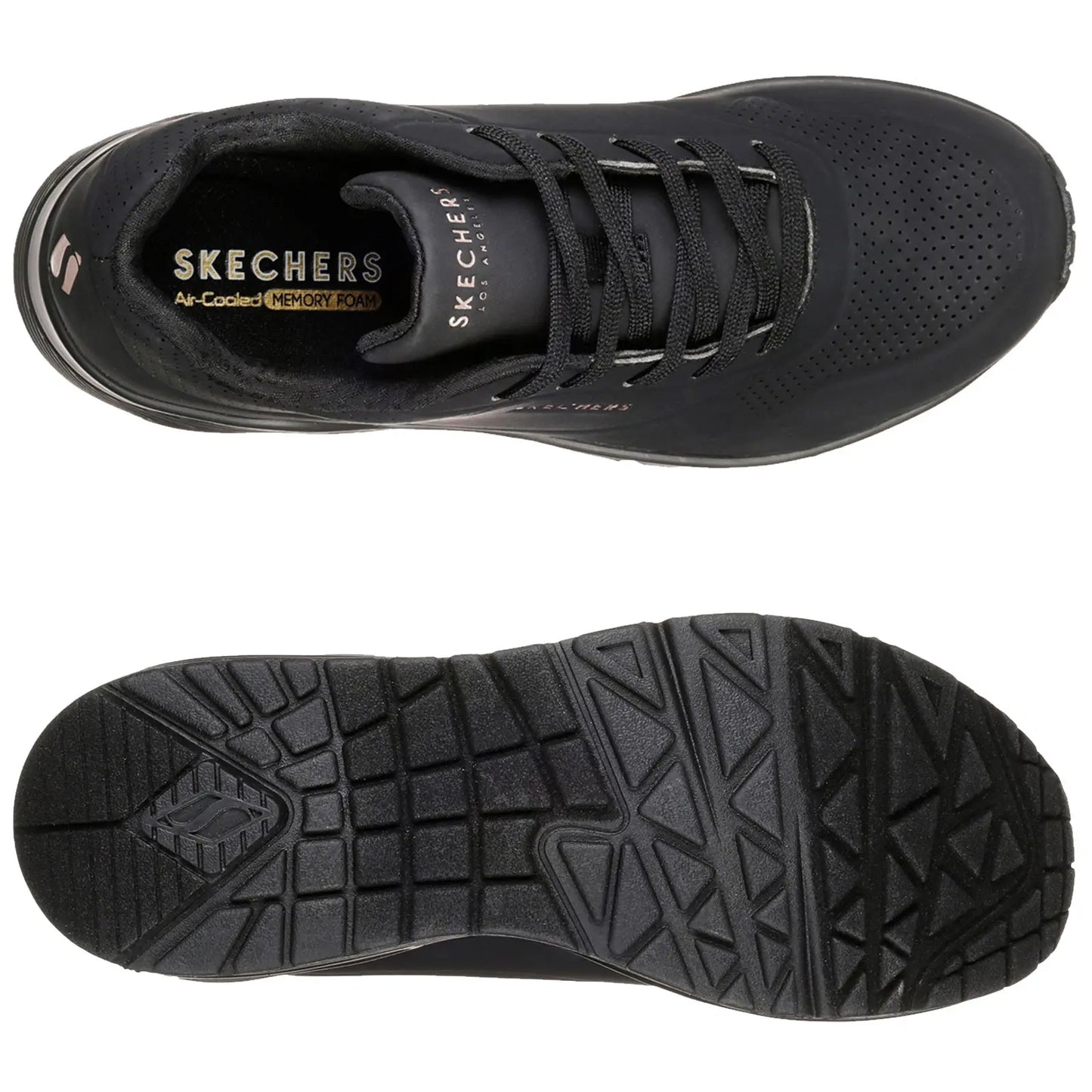 Black sneakers are positioned side by side with one foot slightly raised showcasing their design while a person wearing olive green pants stands in a neutral setting highlighting the footwear.