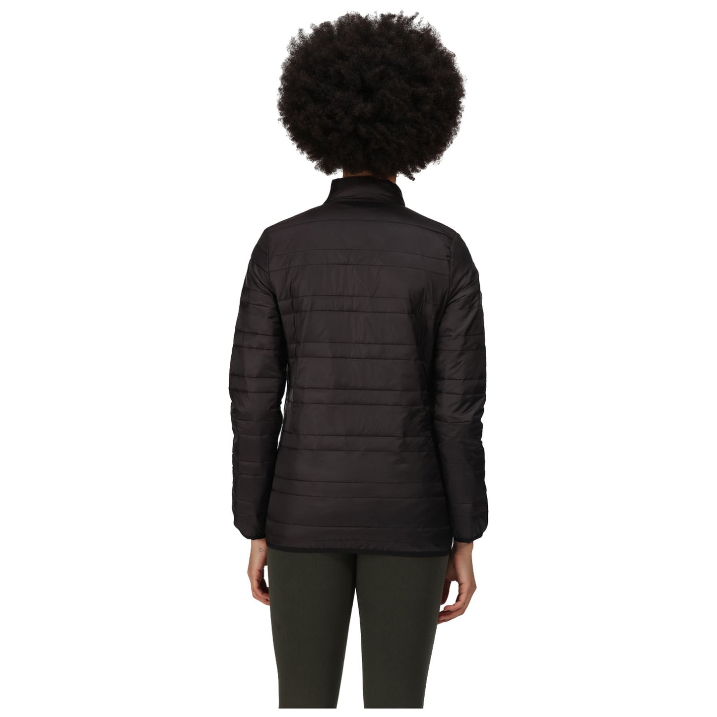 A person is standing with their back to the viewer wearing a black puffer jacket and green pants in a plain white background environment.