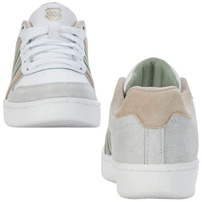 Sneakers are displayed with a white leather and gray suede exterior featuring green accents while positioned vertically against a neutral background highlighting their athletic design and casual appeal