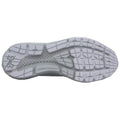 A white athletic shoe sole is displayed showing textured rubber patterns and grip features designed for traction while running or training on various surfaces with Under Armour branding visible.