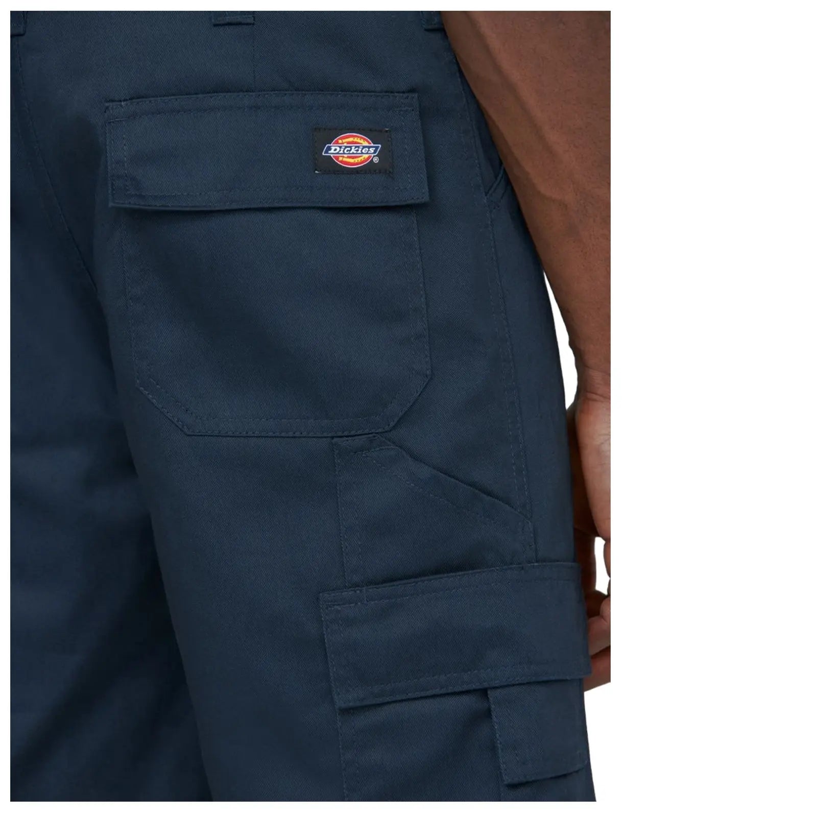 A pair of dark navy pants is displayed showing a close-up view of the side with visible pockets and the Dickies logo stitched on a patch