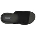 A black Skechers sandal is displayed from above featuring a wide mesh strap and textured sole with the brand name and "Archfit" printed inside the footbed.
