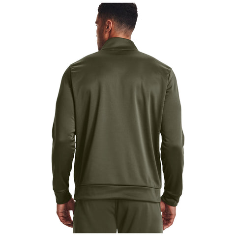 A man is wearing a dark green athletic jacket with a collar and standing with his back facing the viewer in a plain white background.