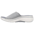 A grey slip-on shoe with a mesh upper and a thick white sole sits on a flat surface showcasing its stylish design and comfort-focused construction.