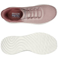 Pink slip-on shoes featuring a textured upper and a flexible white sole are displayed from a top perspective alongside the sole for examination in a neutral background.