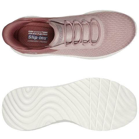 Pink slip-on shoes featuring a textured upper and a flexible white sole are displayed from a top perspective alongside the sole for examination in a neutral background.