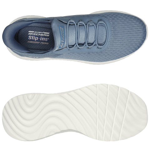 A blue sports shoe with a textured upper features elastic laces for easy wear and a contrasting white sole showcasing a wavy pattern designed for comfort and flexibility.