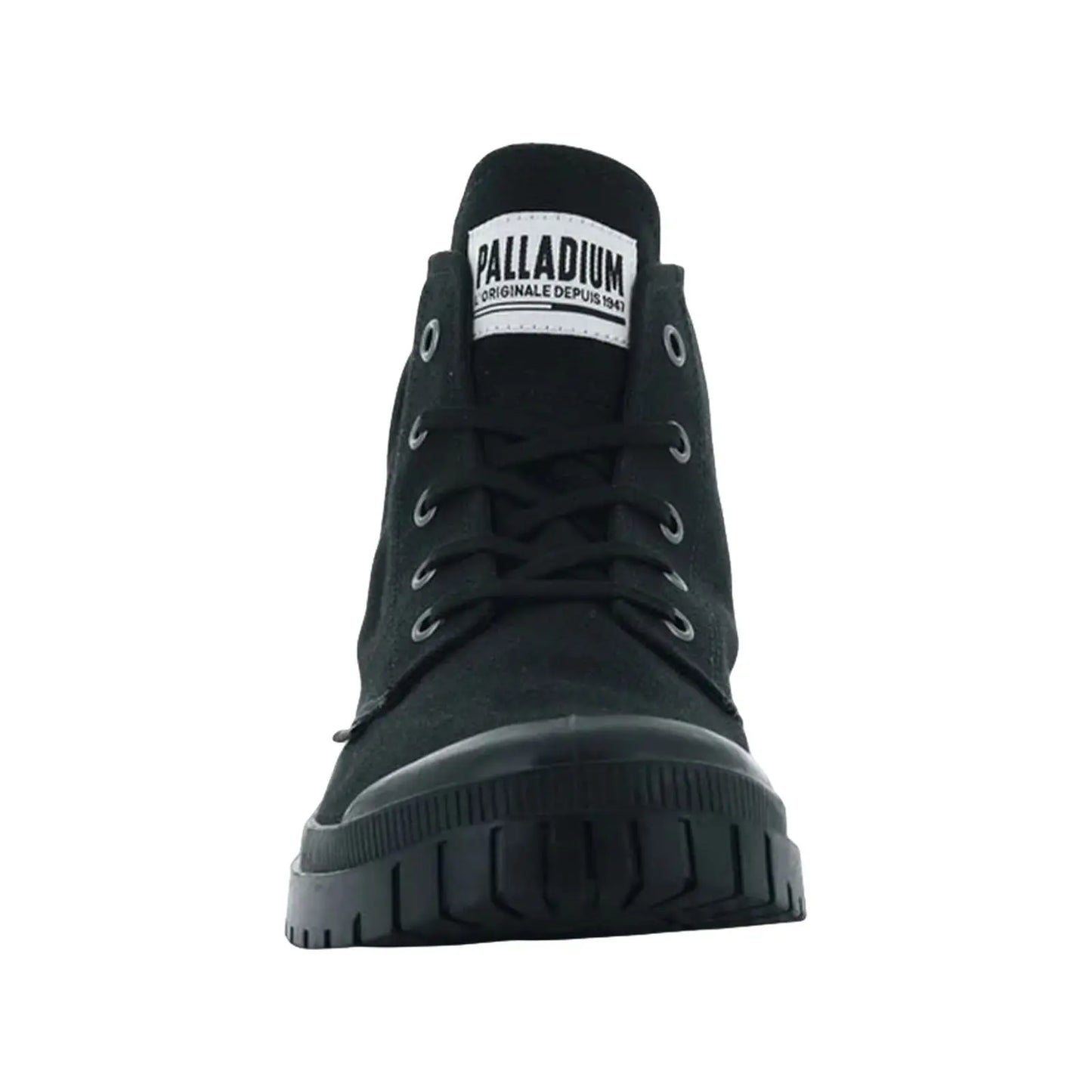 Black high-top shoe stands upright displaying a lace-up front and rubber sole in a simple, uncluttered setting emphasizing its design and branding with label visible on the tongue