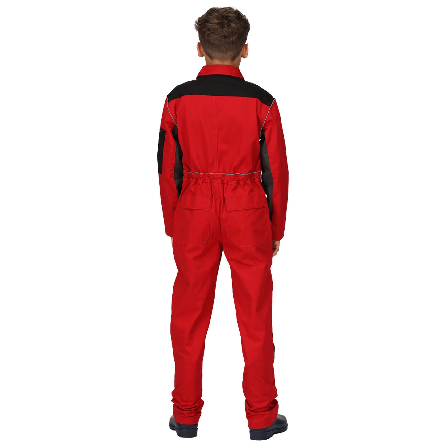 A child stands facing away, wearing a red jumpsuit with black accents and sturdy black footwear, positioned against a plain white background. The outfit is designed for practical purposes.