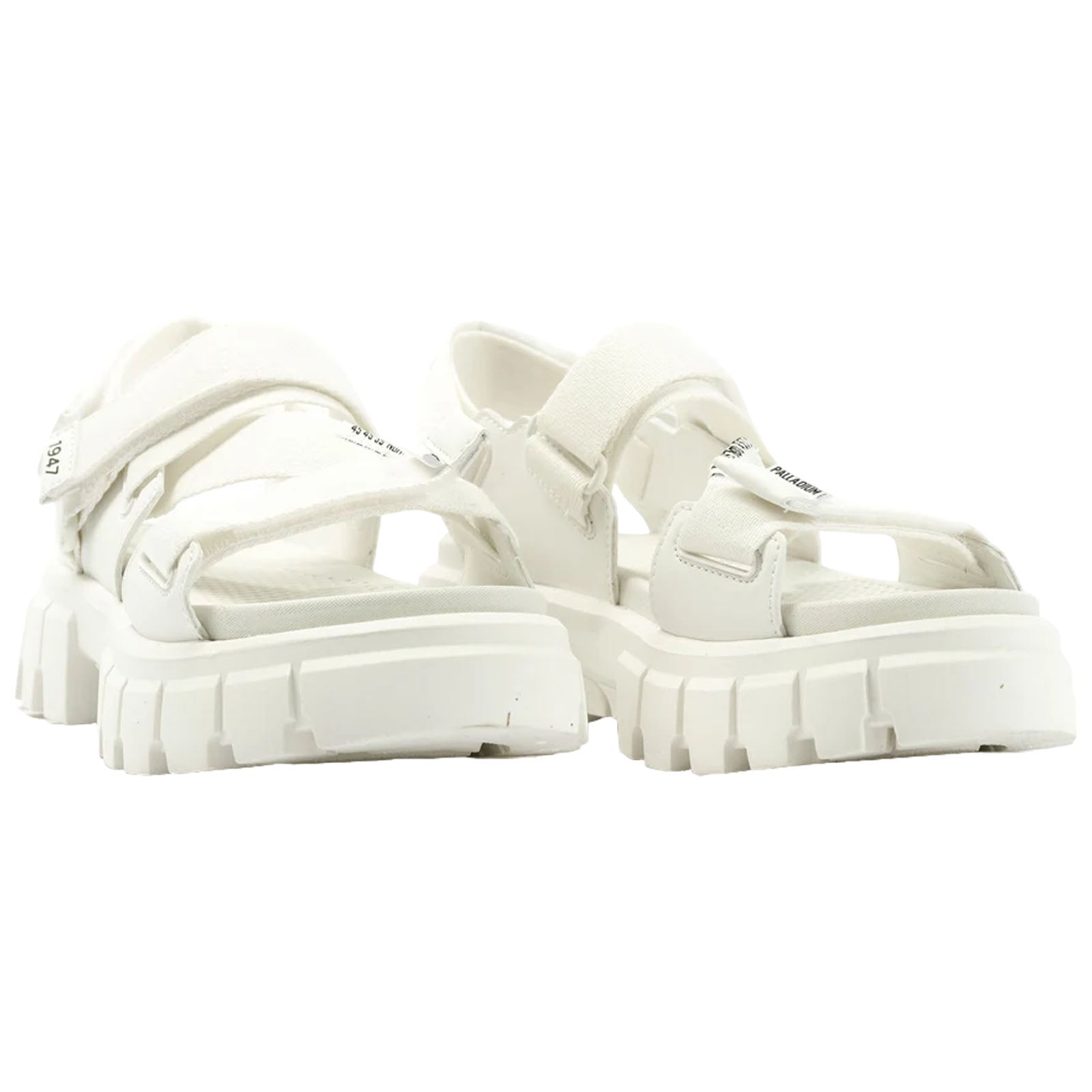A pair of white sandals showcases a thick sole and multiple straps designed for secure fastening resting against a plain background suggesting a focus on footwear display.