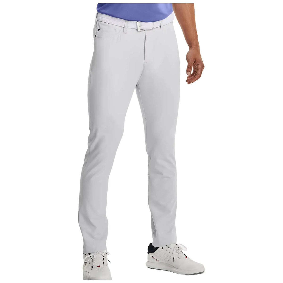 White golf pants are worn by a person standing with one hand on the hip and the other relaxed at their side showing a casual and sporty appearance in an outdoor context.