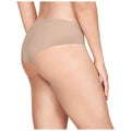 A person stands with their back facing the viewer wearing beige underwear highlighting their curves against a plain white background. Their hand rests on their hip.