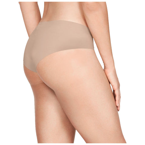 A person stands with their back facing the viewer wearing beige underwear highlighting their curves against a plain white background. Their hand rests on their hip.