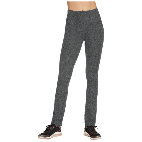 A pair of grey textured leggings is standing upright on a model who is wearing black athletic shoes. The leggings are form-fitting and designed for athletic or casual wear.