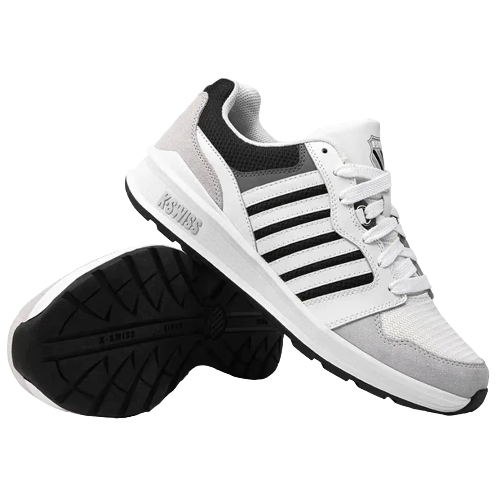 A pair of white and gray sneakers with black stripes is presented upright with one shoe slightly tilted. They are placed on a plain background, showcasing their design and sole pattern.