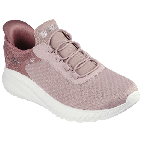 A light pink athletic shoe with a textured surface and elastic laces is positioned slightly to the right against a plain white background showcasing its design and color.