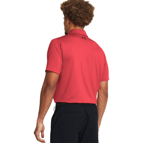 A person with curly hair is wearing a red polo shirt and black pants facing away, showing a casual outdoor or golf-related setting. The shirt has a brand logo on the back.