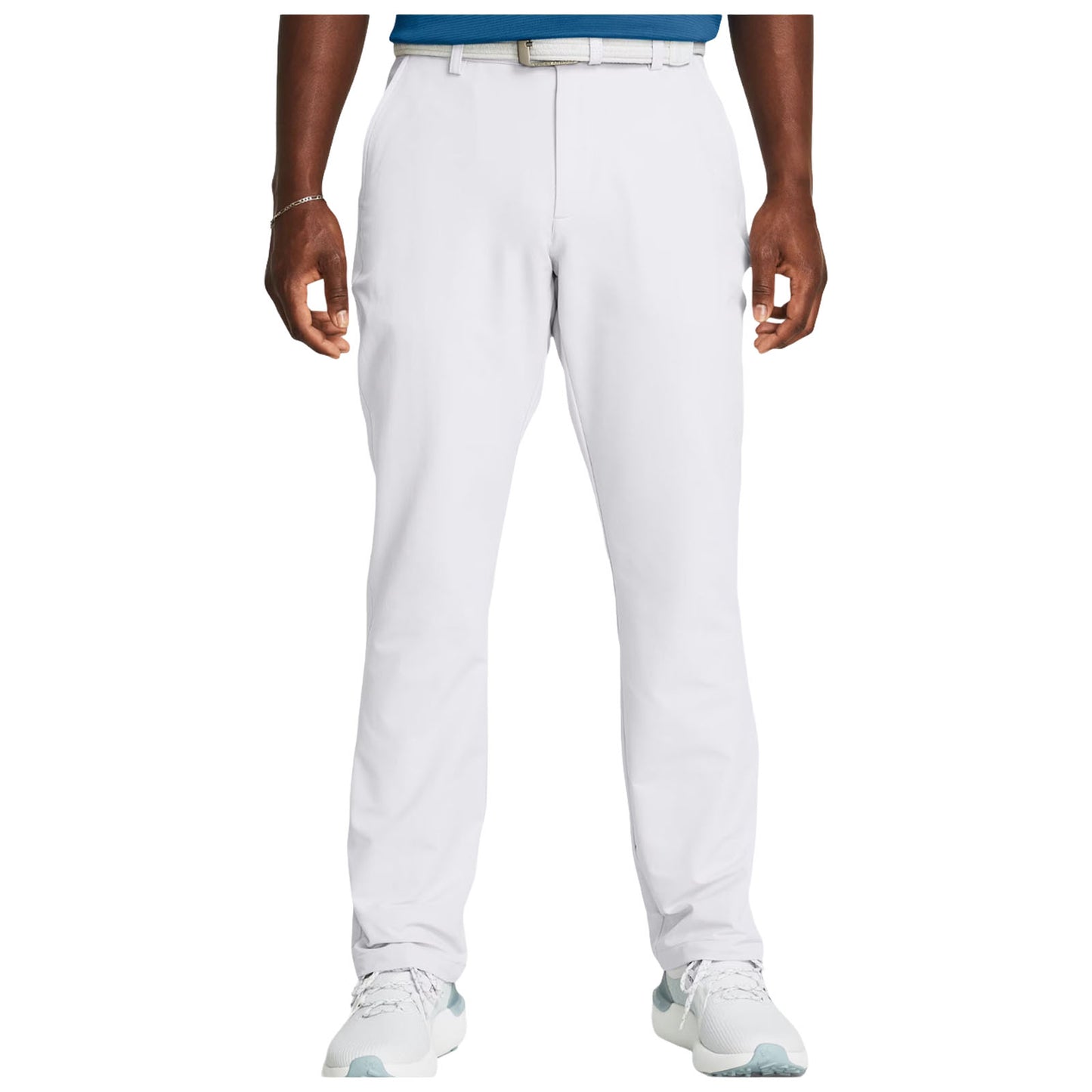 White pants are worn by a person standing upright with hands relaxed. The individual wears a blue shirt and light-colored athletic shoes in a neutral indoor setting.
