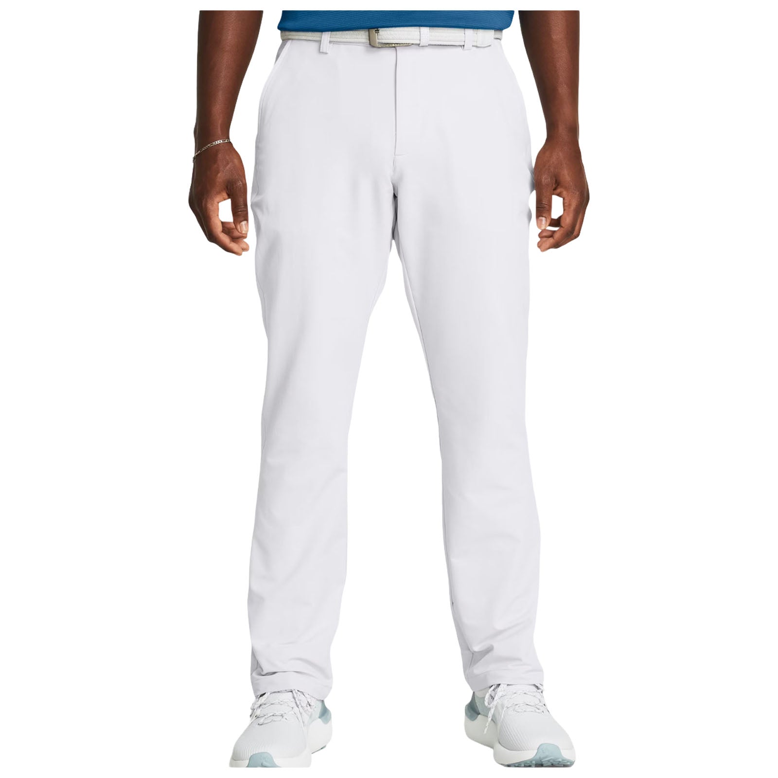 White pants are worn by a person standing upright with hands relaxed. The individual wears a blue shirt and light-colored athletic shoes in a neutral indoor setting.