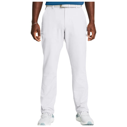 White pants are worn by a person standing upright with hands relaxed. The individual wears a blue shirt and light-colored athletic shoes in a neutral indoor setting.