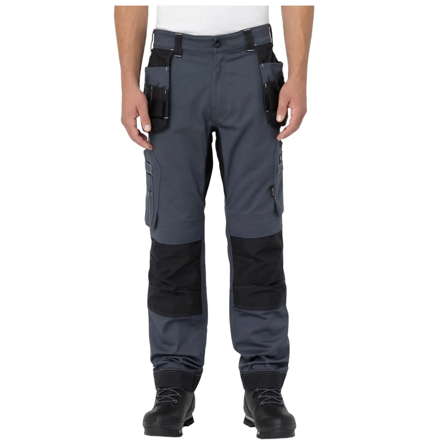 Gray work pants with multiple pockets are being worn by a person standing upright in a neutral position. The pants have reinforced black sections at the knees and are paired with black boots.
