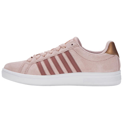A light pink sneaker made of suede features three darker pink stripes on the side and a metallic gold heel cap set against a neutral background.