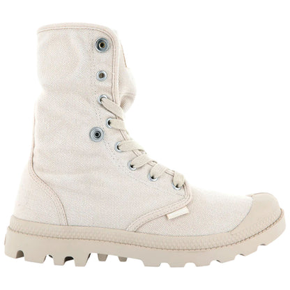 A beige high-top boot made of canvas with a textured surface featuring metal eyelets and laces is positioned upright against a plain white background. The sole is rugged and designed for traction.