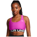 A person is wearing a bright pink sports bra with a black band featuring the text "UNDER" while displaying a confident expression against a plain white background.