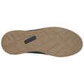 A shoe sole is displayed with a textured rubber bottom designed for traction and grip resting against a light background showing the grooves and patterns for better stability on various surfaces.