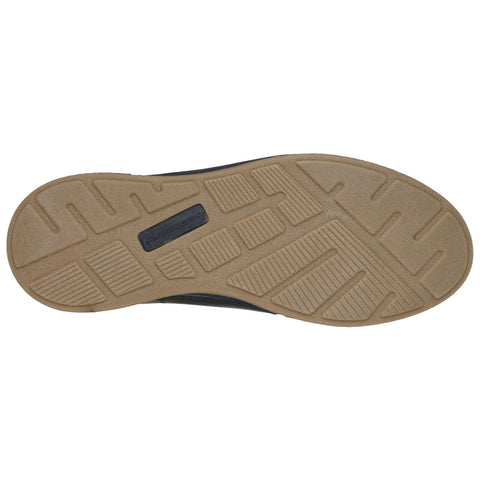 A shoe sole is displayed with a textured rubber bottom designed for traction and grip resting against a light background showing the grooves and patterns for better stability on various surfaces.