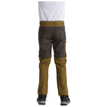 A child is seen from behind wearing two-tone pants with a combination of dark and light brown colors while standing on a flat surface with a white background.