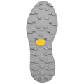 A gray shoe sole features a rugged tread design with various shapes and patterns providing traction significant for outdoor activities and sporting contexts with a yellow vibram logo prominently displayed.