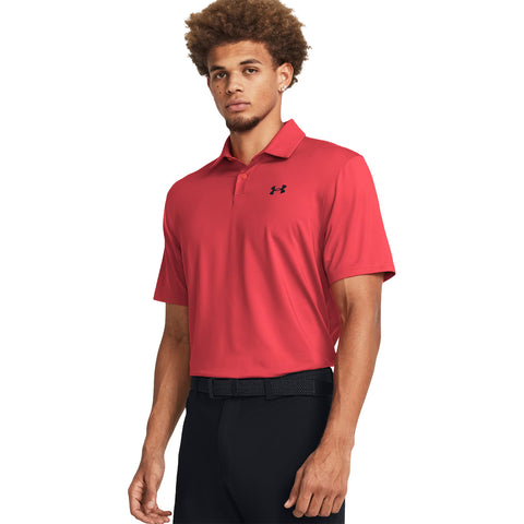 A young man stands confidently wearing a red polo shirt with a black logo and black pants, posed against a plain white background, emphasizing the outfit's sporty and stylish appearance.