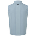 A light blue sleeveless golf vest hangs vertically showcasing a smooth texture and a high collar with a subtle logo at the back in a casual indoor display.