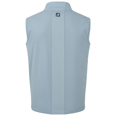 A light blue sleeveless golf vest hangs vertically showcasing a smooth texture and a high collar with a subtle logo at the back in a casual indoor display.