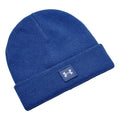 A blue knit beanie sits flat displaying a folded cuff with a small brand logo patch on the front the fabric appears soft and warm suggesting use in cold weather conditions