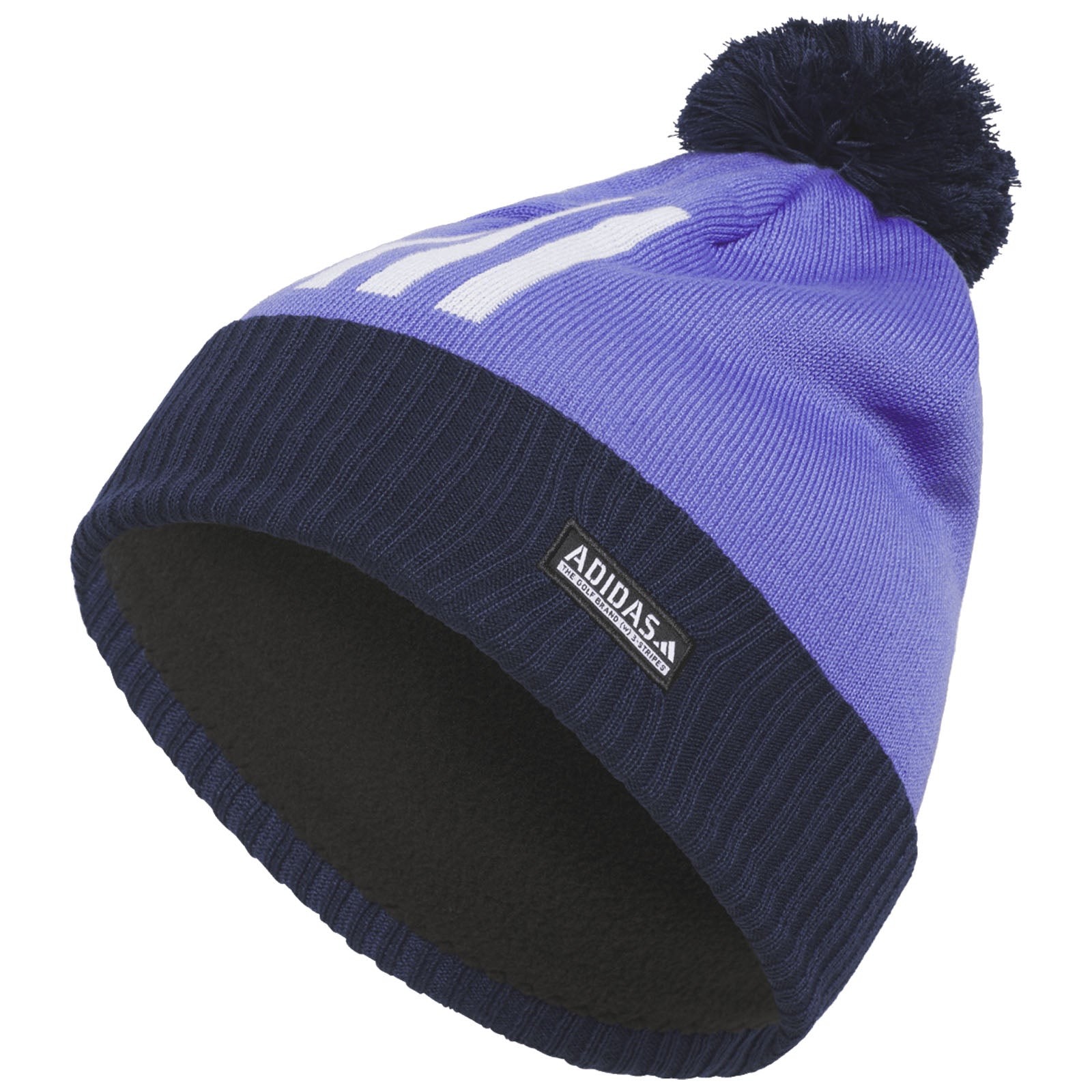 A purple knit beanie with a black pom-pom sits upright showing a navy ribbed cuff and an Adidas label along the side suggesting a cozy winter accessory for outdoor wear.