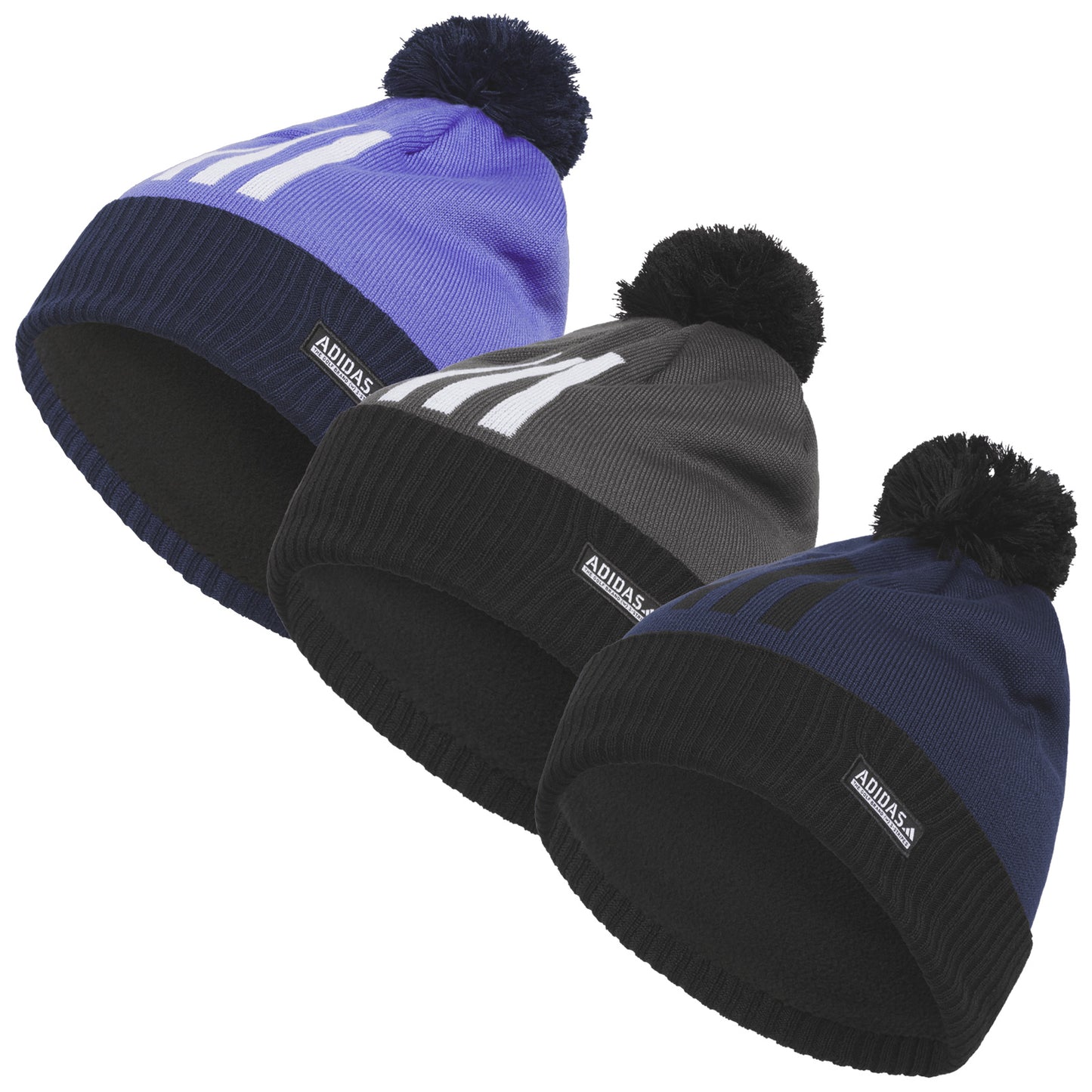 Three beanies are displayed in a row. Each beanie features a pom-pom on top and a different color: purple, gray, and navy. The inside is lined for warmth.