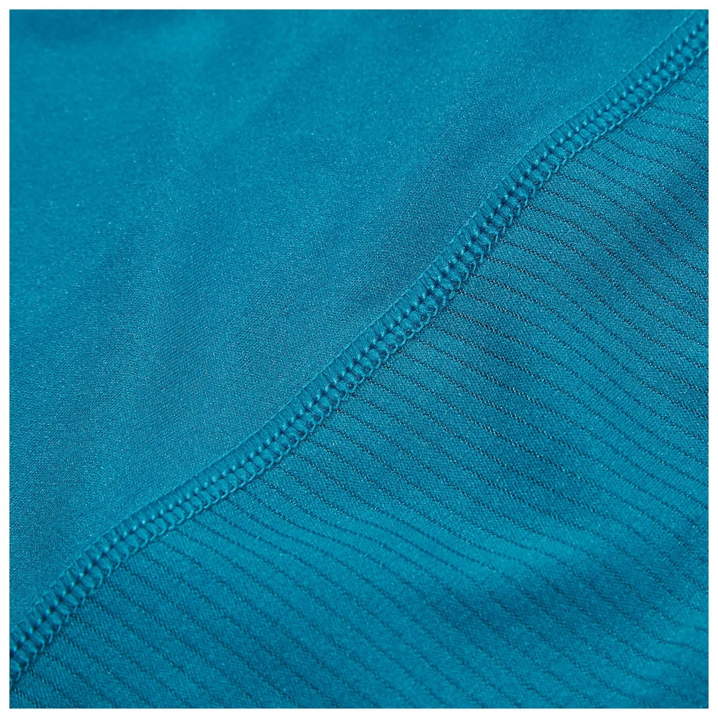 A piece of fabric in a vibrant teal color displays two different textures with a smooth section transitioning to a ribbed section along the edge showcasing careful stitching for durability.