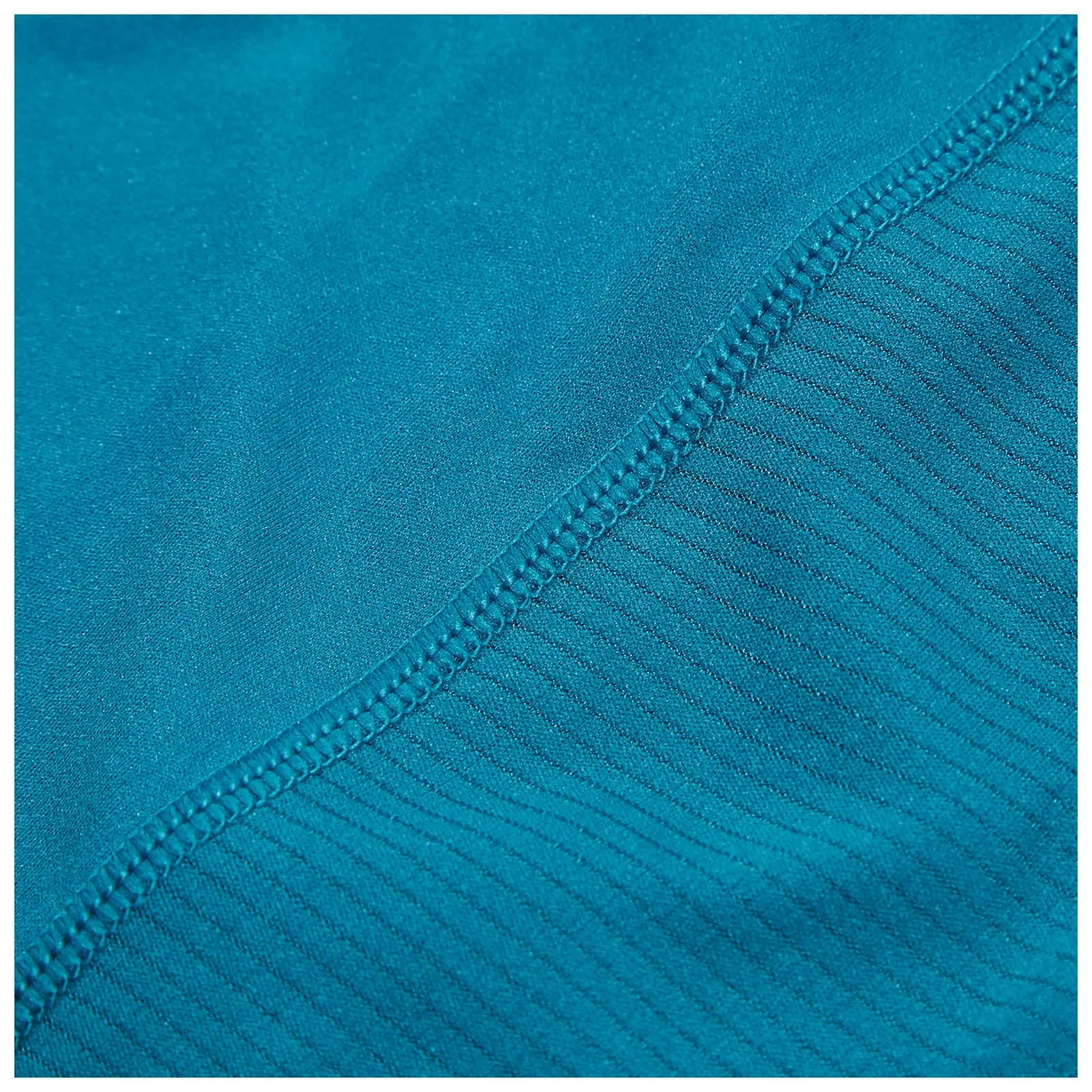 A piece of fabric in a vibrant teal color displays two different textures with a smooth section transitioning to a ribbed section along the edge showcasing careful stitching for durability.