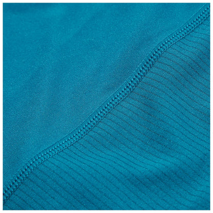 A piece of fabric in a vibrant teal color displays two different textures with a smooth section transitioning to a ribbed section along the edge showcasing careful stitching for durability.