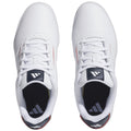 A pair of white athletic shoes with perforated sides laces and a navy accent on the tongue lies flat against a neutral background highlighting their sleek design and sporty appearance.