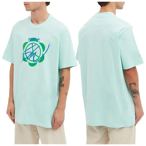 A light blue oversized t-shirt with a graphic design is being worn by a person standing in a neutral setting showcasing both the front and back views.